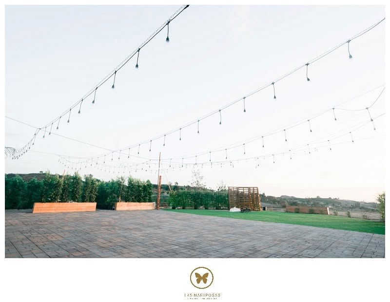Open-air courtyard with string lights overlooking the hills