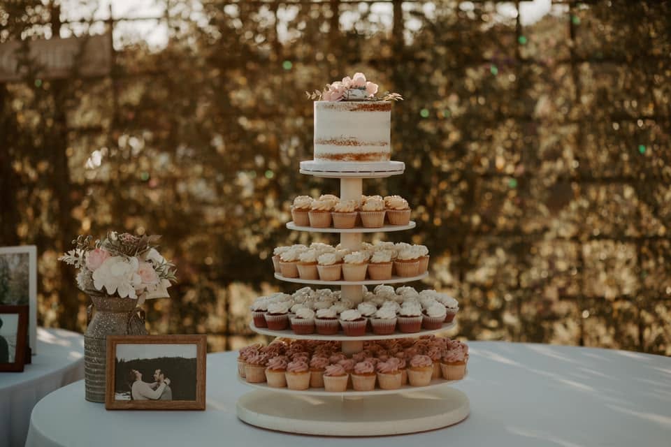 Cake and cupcake tower styled in the venue garden
